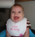 Baby Quinnessa smiling in her bib